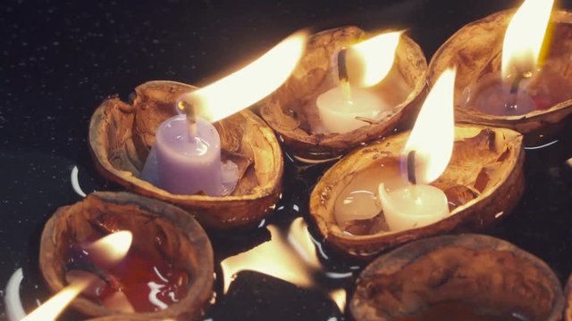 The hard woody covering around the kernel of a nut with candle in.Romantic Candles in a nutshell float on water.Czech Republic tradition.