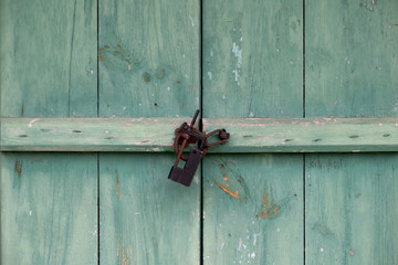 Korean traditional, closed green doors and locks of old technology