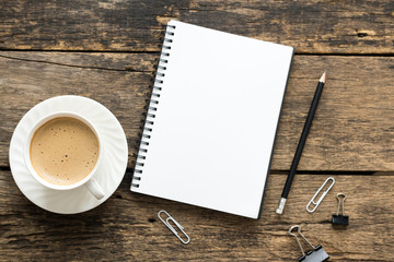 Empty notebook and coffee on  wooden table