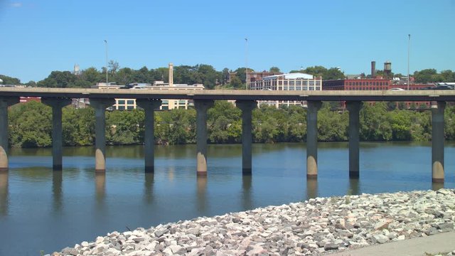 Richmond VA Bridge with Interstate 95 Traffic Driving over the James River with Old Historical Tobacco Factories and Water Towers in the Background on a Sunny Day