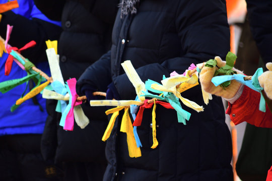 People holding a rope tied with colored paper