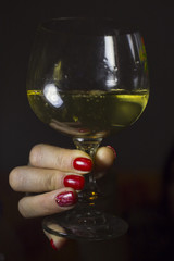 A glass of wine in hand. Girl holding a glass of Drinking.