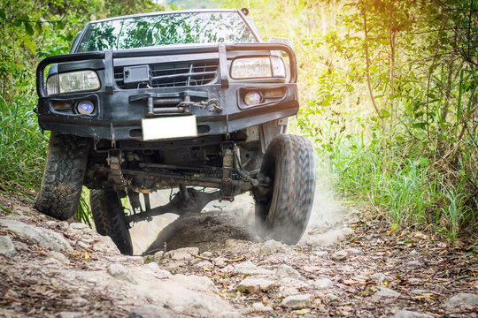 4 wheel drive is climbing on a difficult off-road in mountain forests in Thailand.