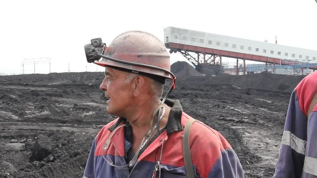 miners against the background of the mine in summer