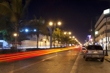 Palestine street in Jeddah at night, with car lights motion