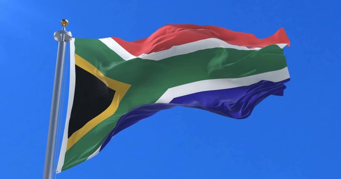 Flag of South Africa waving at wind in slow in blue sky, loop