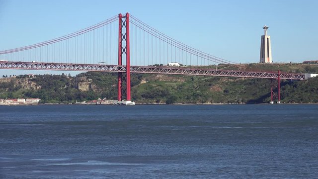 25th of April Bridge suspension bridge over river Tejo with Jesus Christ the King Statue on background in Lisbon. Portugal