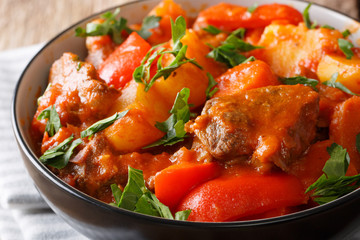 Filipino cuisine: Mechado beef with vegetables in spicy sauce close-up in a bowl. horizontal
