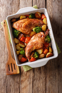 Homemade dietary rabbit baked with vegetables close-up in a baking dish. Vertical top view