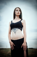 Fototapeta premium Portrait of beautiful young woman in the field
