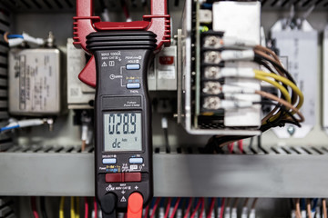 Electrical Engineer is check electrical equipment with a multi-meter
