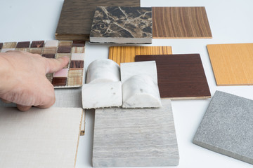 samples of material, wood , color ,ceramic , on wooden table on white background .Interior design select material for idea.