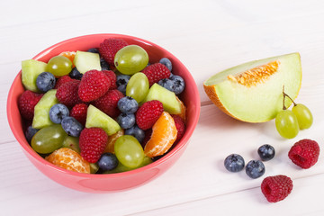 Fresh pepared fruit salad in glass bowl, healthy nutrition concept