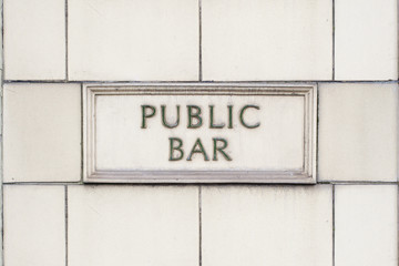 pub public bar sign on white brick background