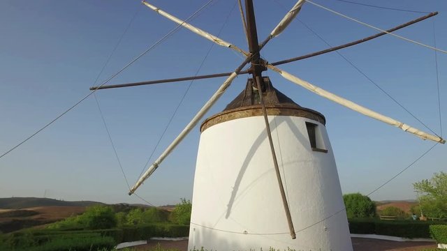 Old traditional windmill on the hill near El Granado in Andalusia, Spain