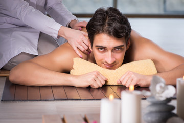 Obraz na płótnie Canvas Young handsome man during spa procedure