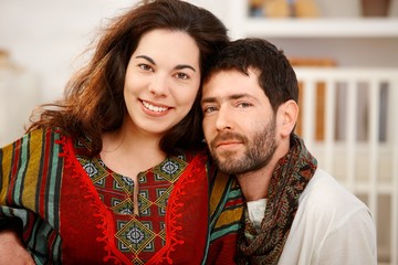 Young couple looking at camera smiling.