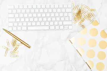 Office styled stock. Keyboard and stationery of gold color.
