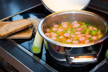 vegetable soup on stove with leek and bread