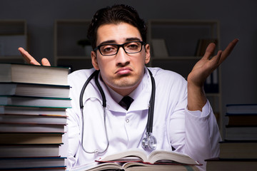 Medical student preparing for university exams at night