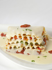 A lunch plate of lasagna with white sauce