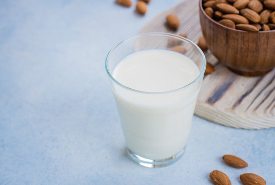 Vegan Nut Milk. Almond Milk in glass and bowl with nuts. Copy space