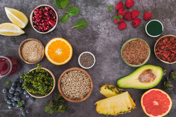 Superfoods. An arrangement of superfoods featuring seeds, legumes, fruits and vegetable. Top view, blank space, dark background