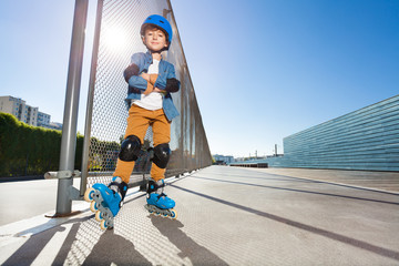 Young inline skater standing at outdoor rollerdrom