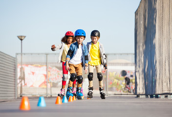 Young inline skaters exercising on slalom course