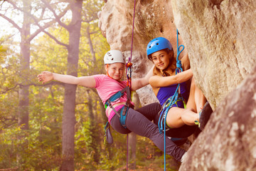 Two climbers abseiling training on steep rock - obrazy, fototapety, plakaty