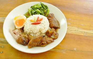 pork trotters stew and boiled egg with rice on plate