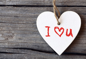 Valentines Day holiday background.Decorative white wooden heart with I love You inscription.I Love You,St Valentine's Day or Love concept.Selective focus.
