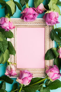Happy Mother's Day, Women's Day, Valentine's Day or Birthday Flat Lay Background. Beautiful wooden vintage picture frame, fresh pink roses and copy space.