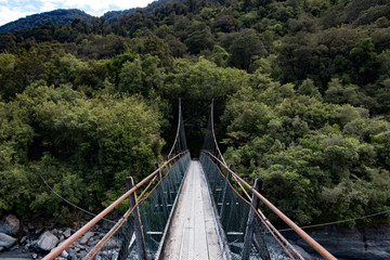 Fototapeta premium New Zealand Fox Glacier old historic wooden swing bridge