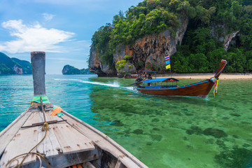 Fototapeta na wymiar wooden boats in the water of the Andaman Sea, beautiful scenery of the resort of Krabi