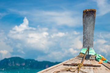 Fototapeta premium close-up part of a wooden Thai boat nose and clouds in the frame