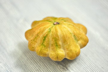Yellow bush pumpkins on white wood background small depth of sharpness