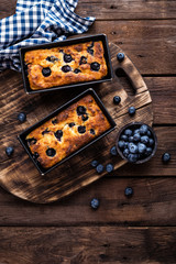 Cheesecake with blueberry on wooden background, top view