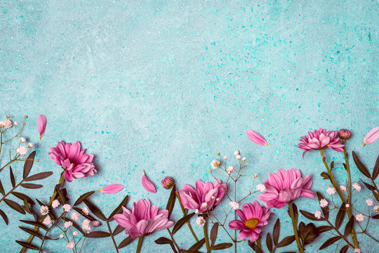 Fototapeta Spring Summer Creative nature background. Pink flowers border on vintage blue background