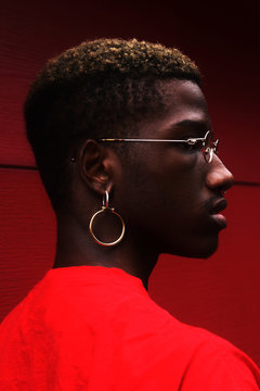 Portrait of young man wearing eyeglasses and a hoop earring