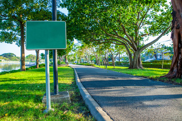 Blank sign on Road pathway Jogging track in the  public park under big tree