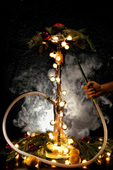 Christmas hookah with tangerines and garlands