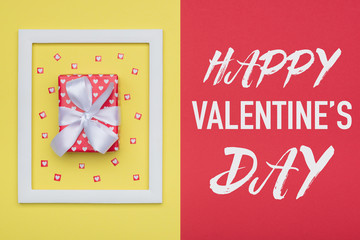 Happy Valentine's Day Pastel Candy Colors Background. Valentines day flat lay minimal concept with beautifully wrapped present and loads of tiny hearts.