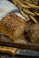 Wholegrain bread with seeds sliced on board