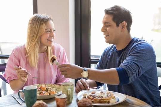 Couple Having Breakfast Together At Restaurant