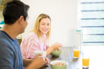 Obraz na płótnie Canvas Beautiful woman enjoying breakfast with her boyfriend