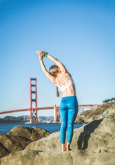 Woman doing yoga on the beach