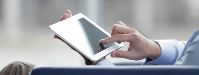 businessman holding digital tablet, closeup