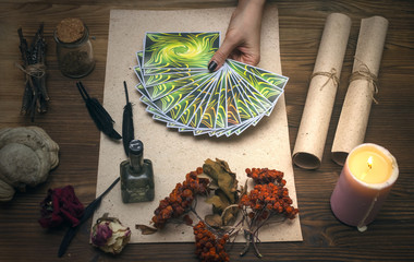 Tarot cards on fortune teller desk table. Witch doctor. Witchcraft. Magic herbal collection.