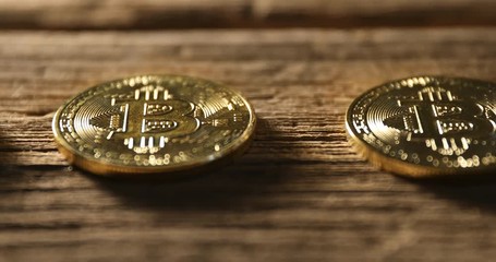 Bitcoin. Physical bit coin. Digital currency. Cryptocurrency. Golden coins on wood